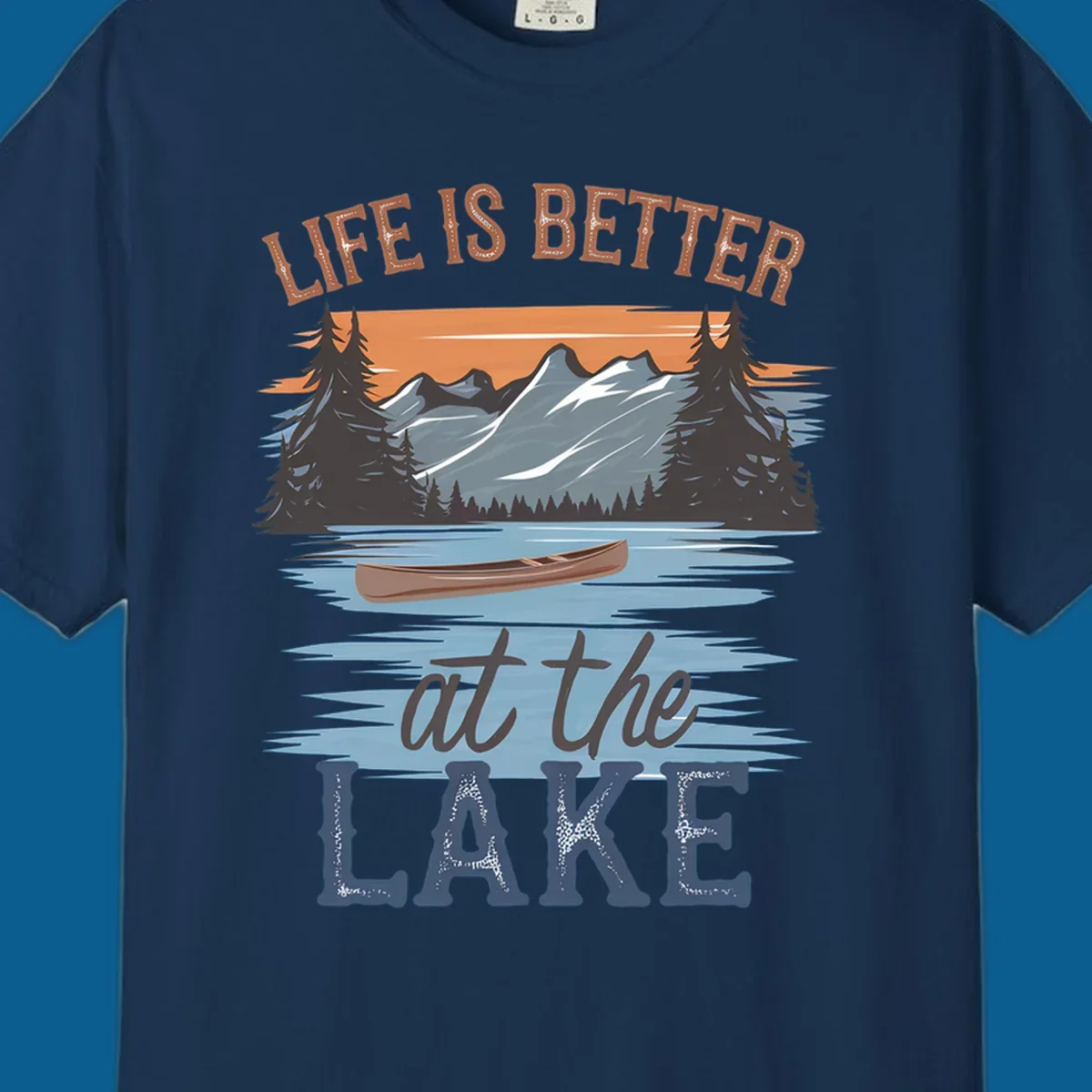 Life is better at the lake scenic design with mountains, canoe, and text.