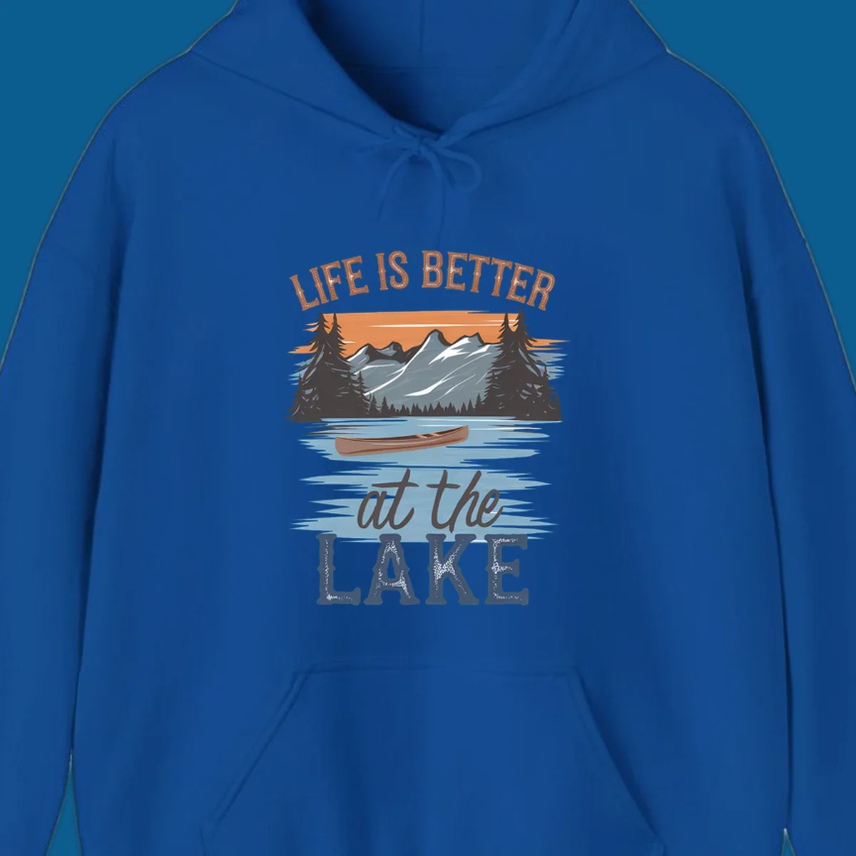 Life is better at the lake scenic design with mountains, canoe, and text.