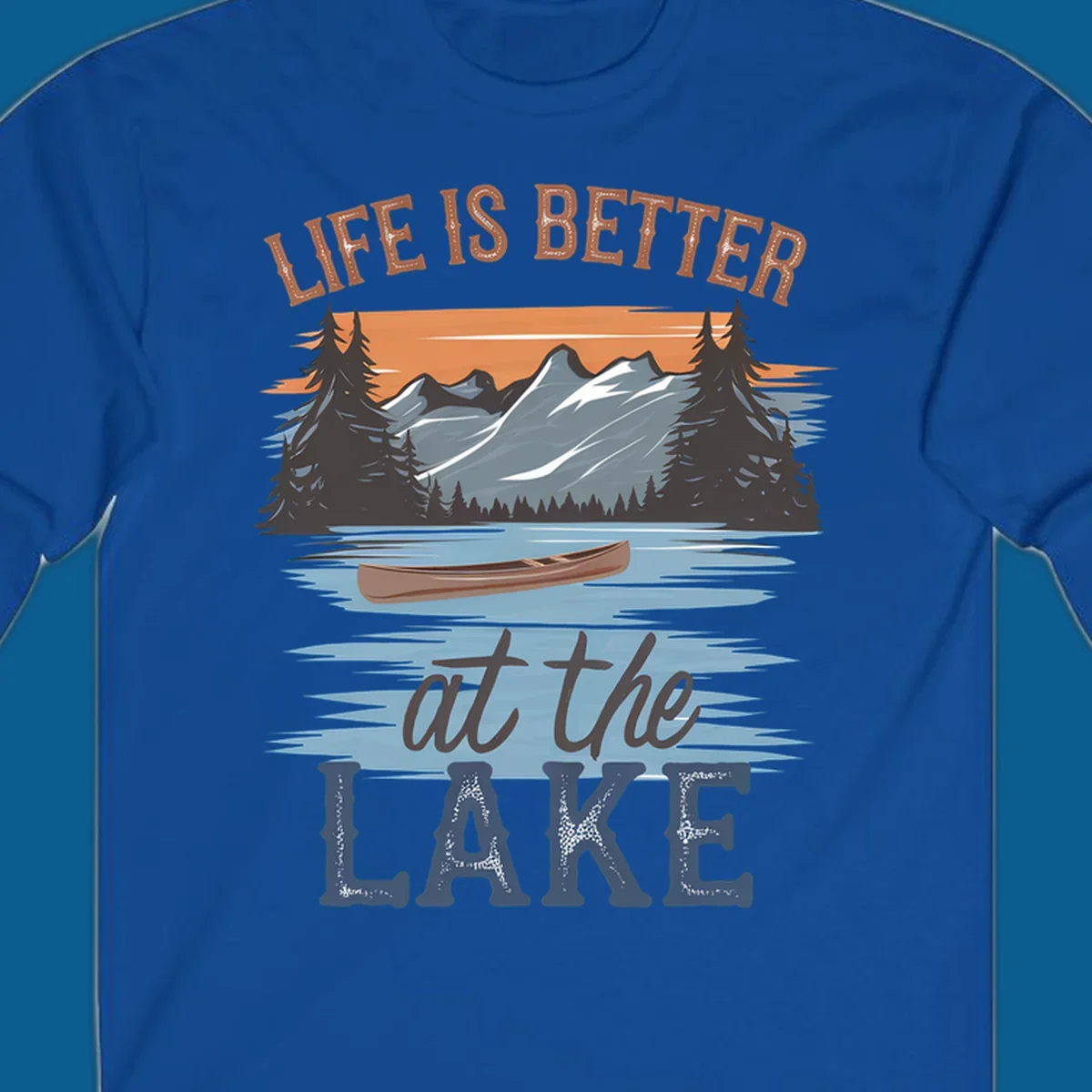 Life is better at the lake scenic design with mountains, canoe, and text.
