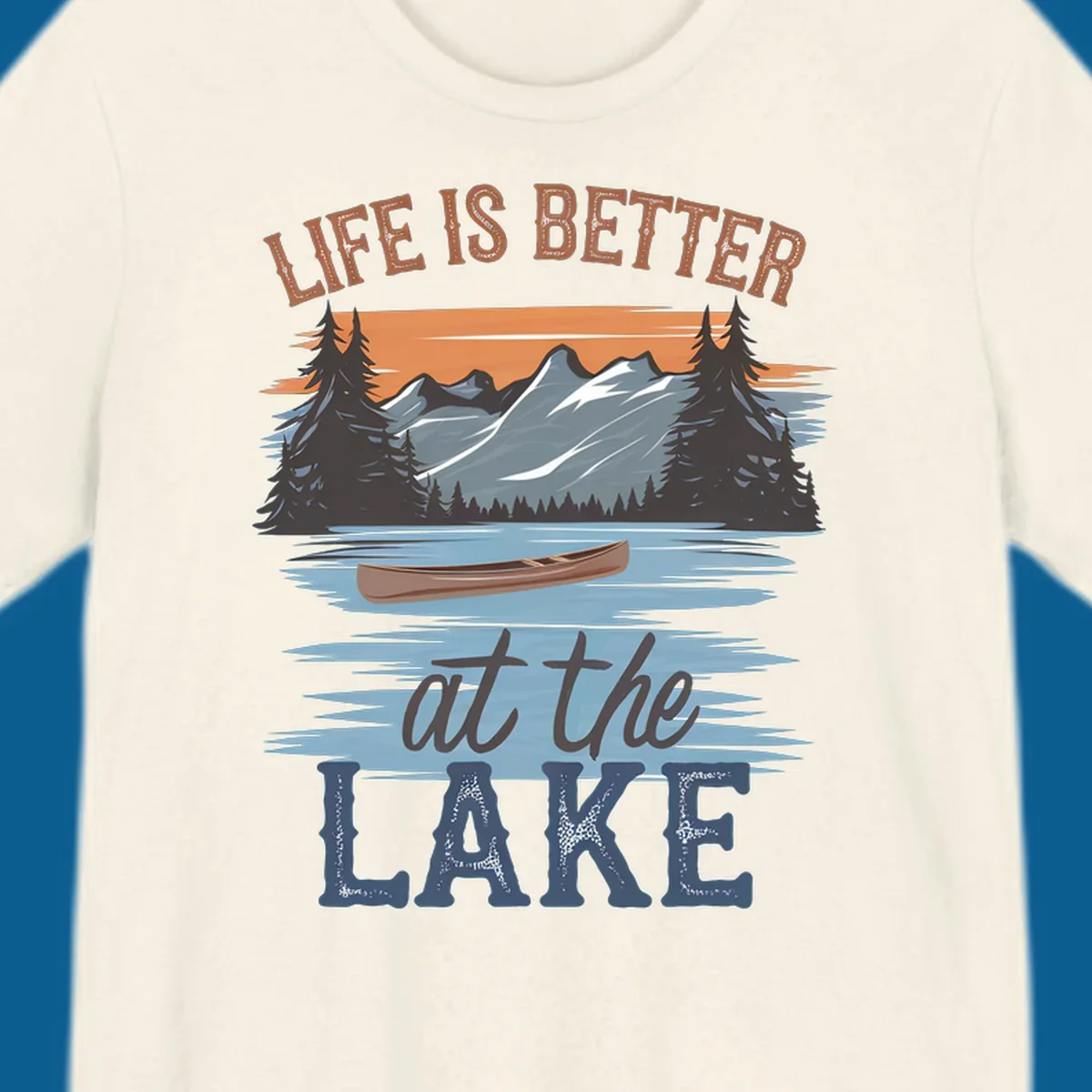 Life is better at the lake scenic design with mountains, canoe, and text.