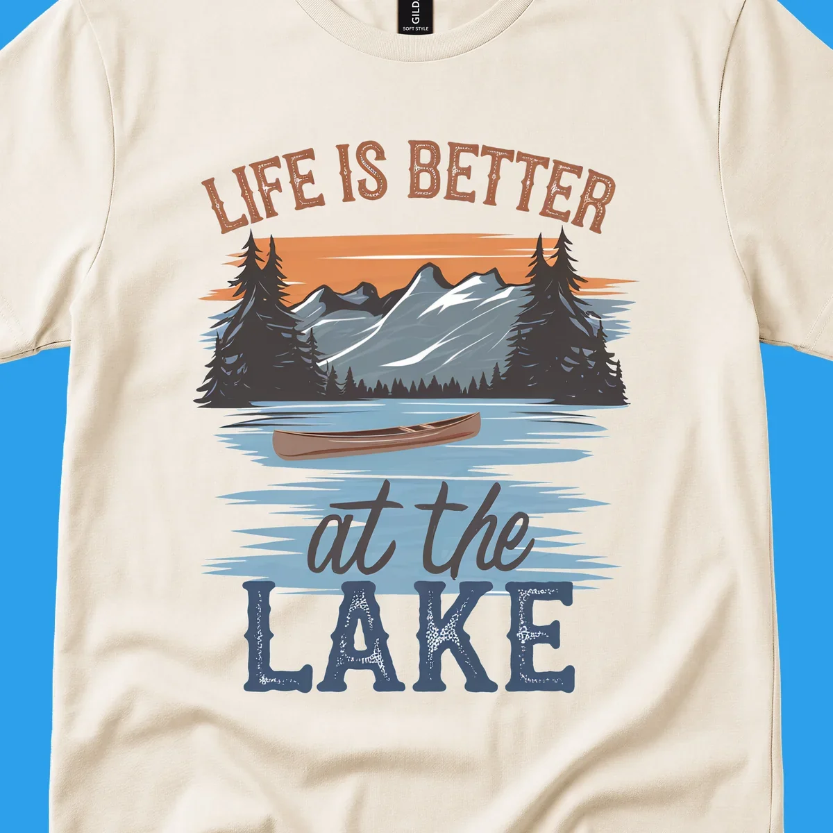Life is better at the lake scenic design with mountains, canoe, and text.