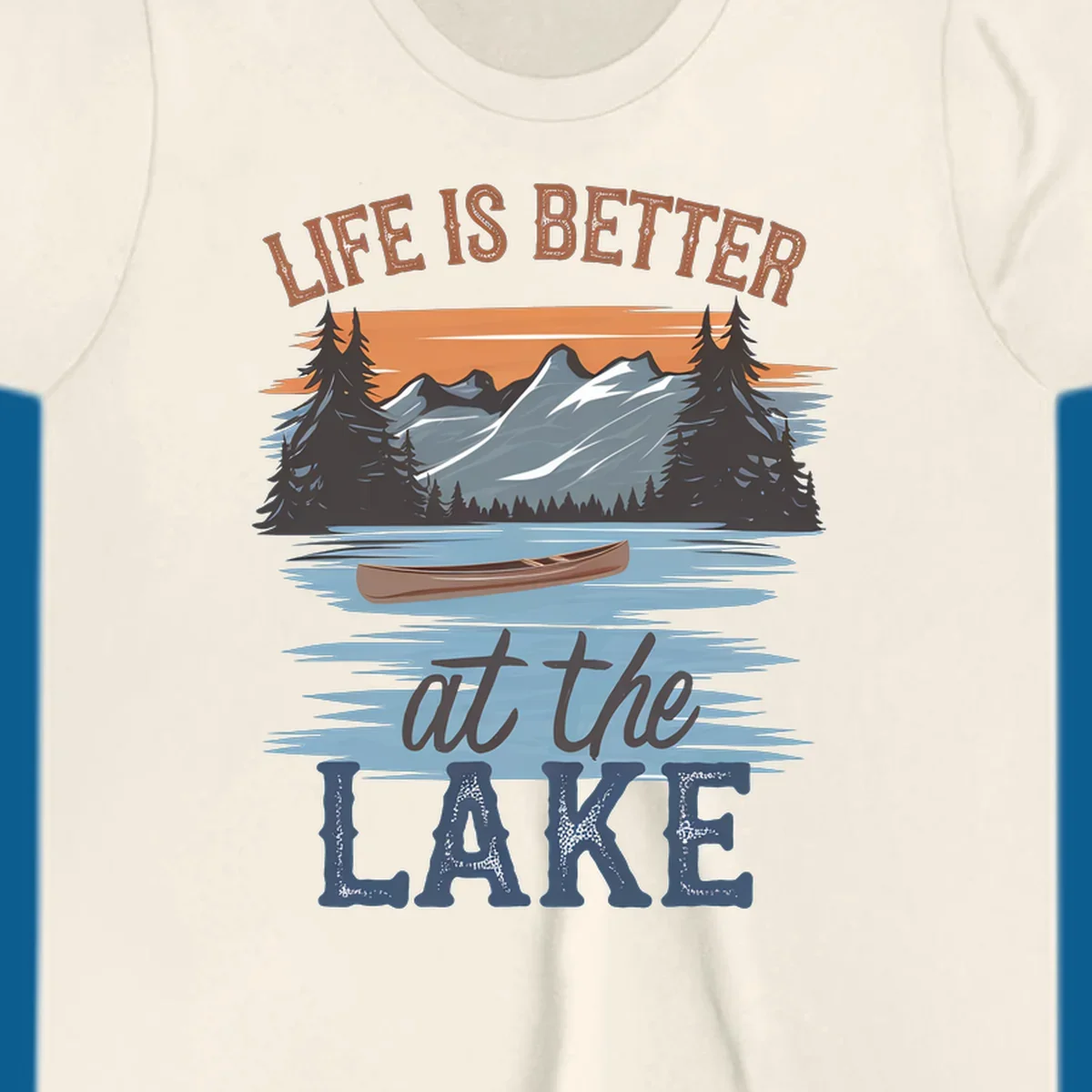 Life is better at the lake scenic design with mountains, canoe, and text.