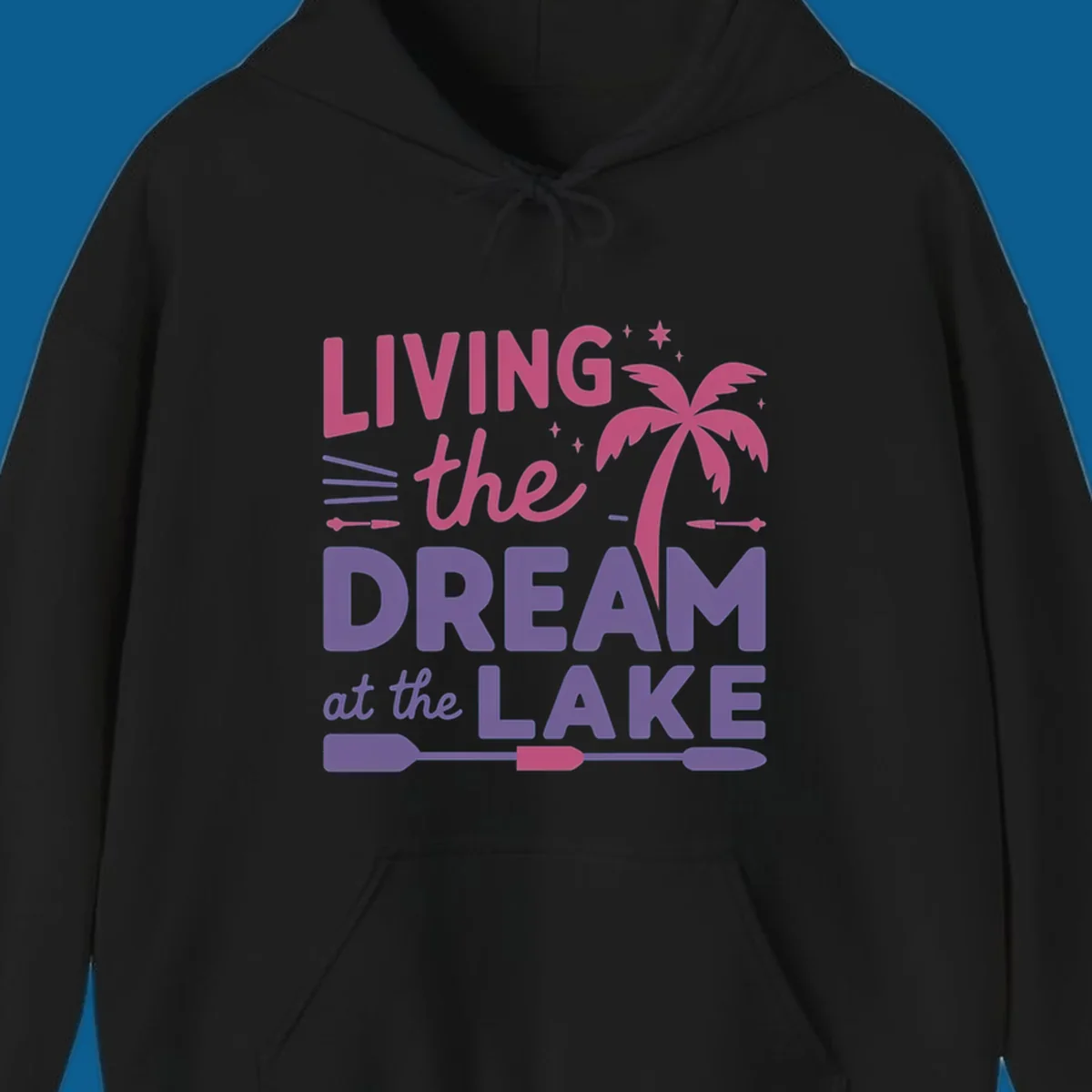 Living the dream at the lake text with palm tree and oars graphic
