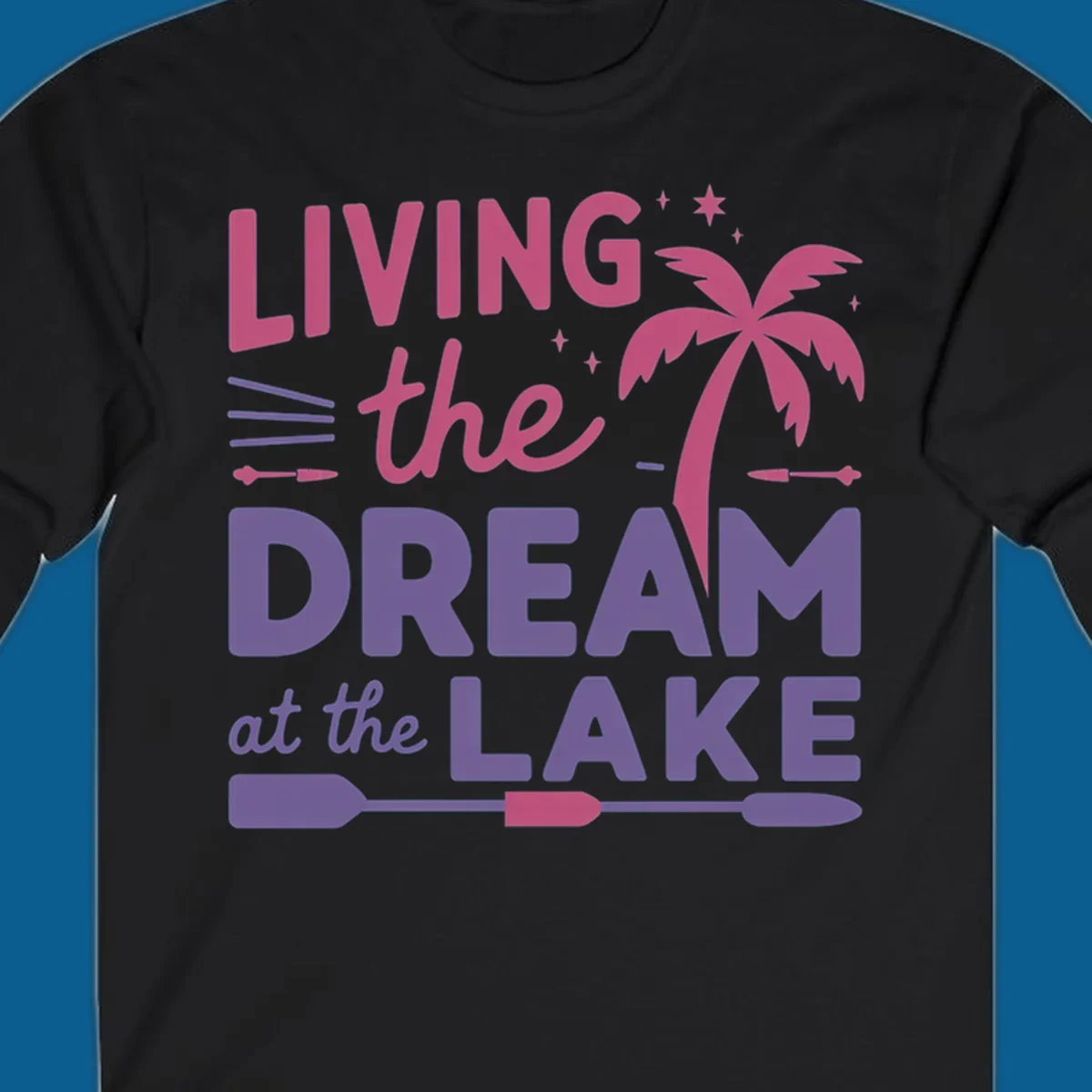Living the dream at the lake text with palm tree and oars graphic