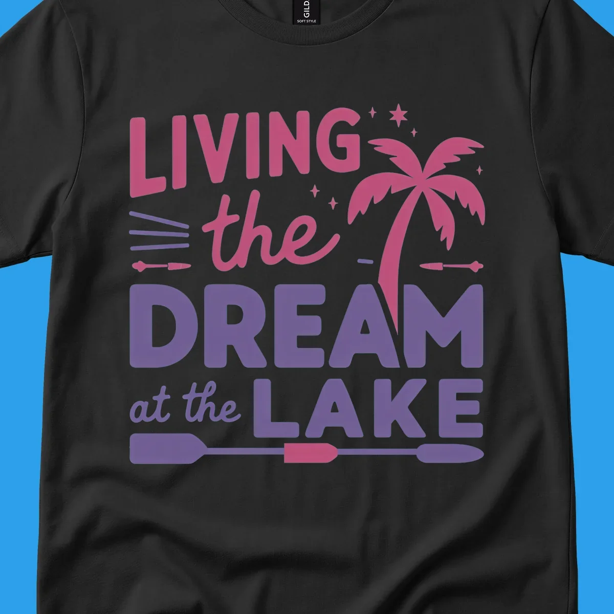 Living the dream at the lake text with palm tree and oars graphic