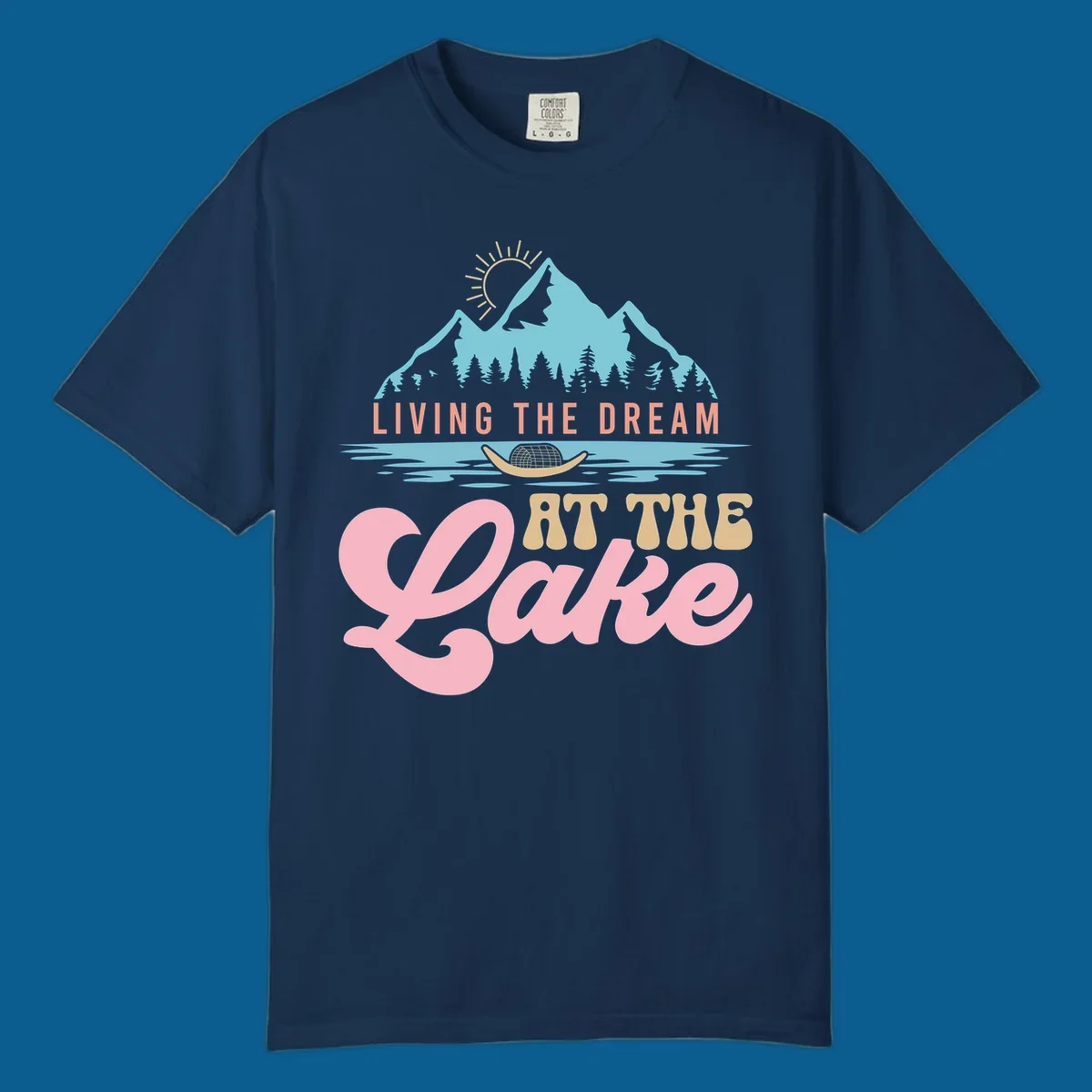 Illustration of mountains and lake with text 'Living The Dream At The Lake', representing the lake-life-dream concept.
