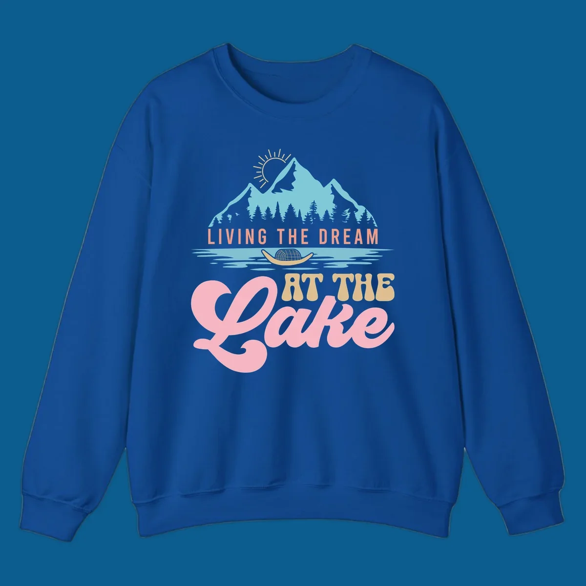 Illustration of mountains and lake with text 'Living The Dream At The Lake', representing the lake-life-dream concept.