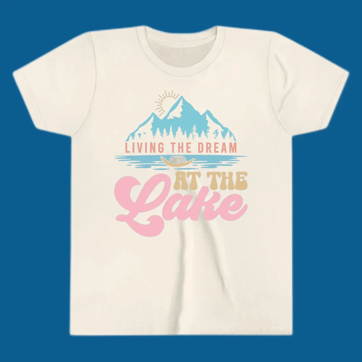 Illustration of mountains and lake with text 'Living The Dream At The Lake', representing the lake-life-dream concept.