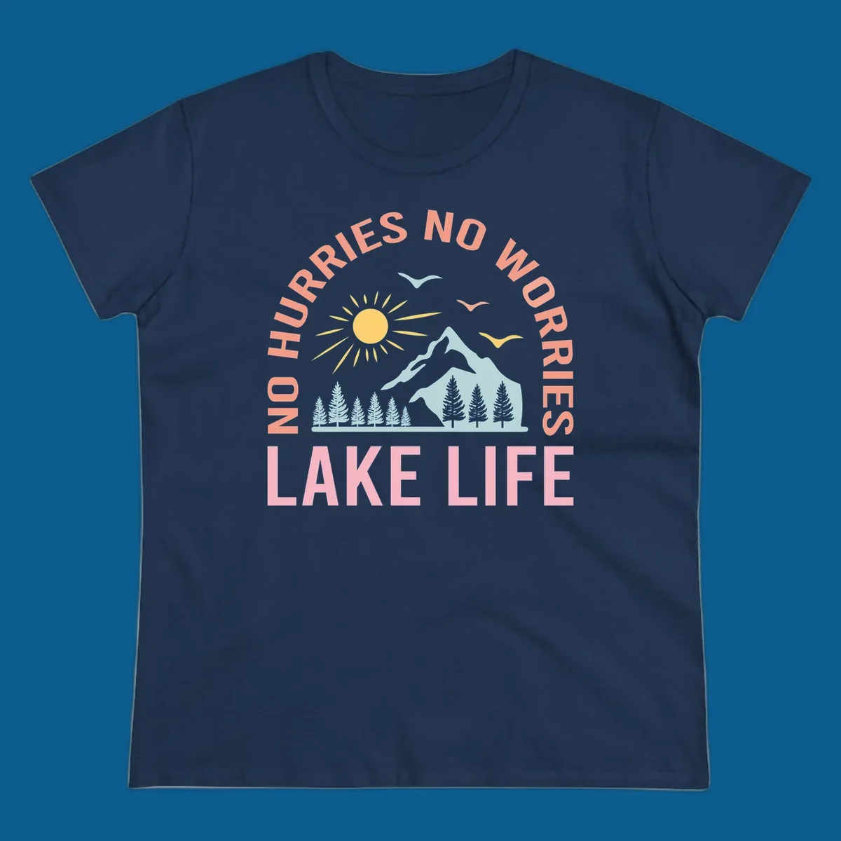 Lake life scenic design with mountains, sun, trees, and no worries text.