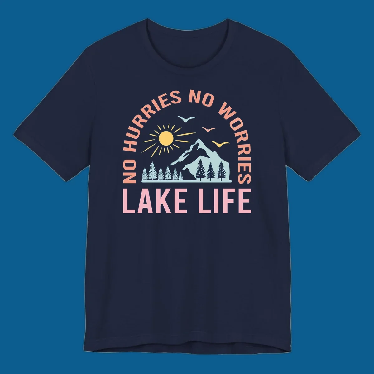 Lake life scenic design with mountains, sun, trees, and no worries text.
