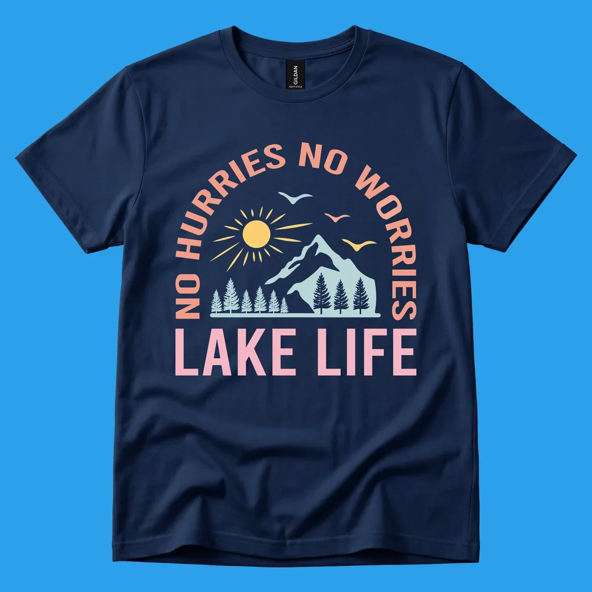Lake life scenic design with mountains, sun, trees, and no worries text.