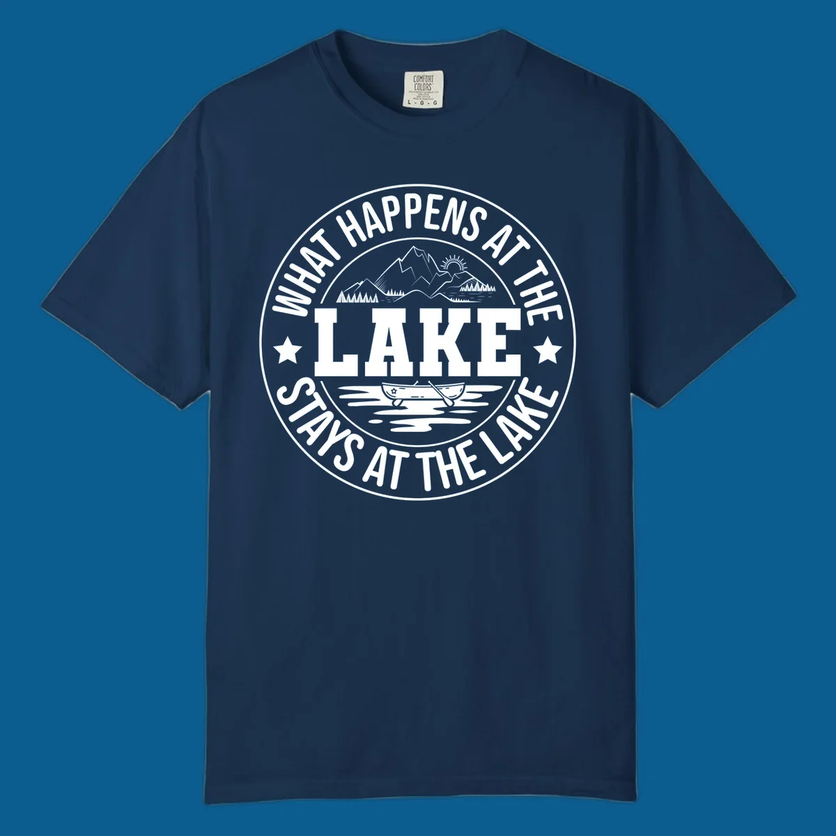 Circular badge with text 'What Happens At The Lake Stays At The Lake' and lake scene graphic.