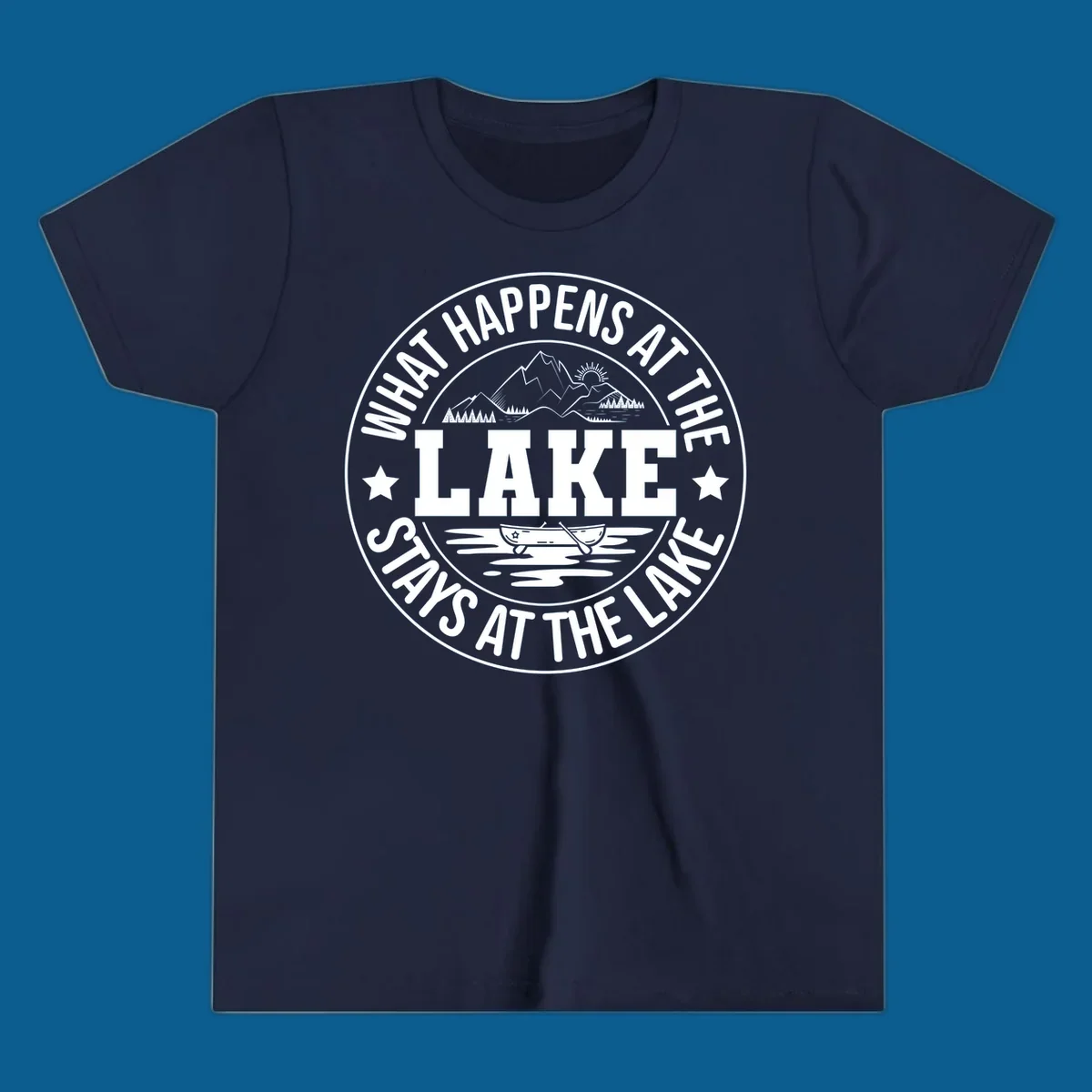Circular badge with text 'What Happens At The Lake Stays At The Lake' and lake scene graphic.