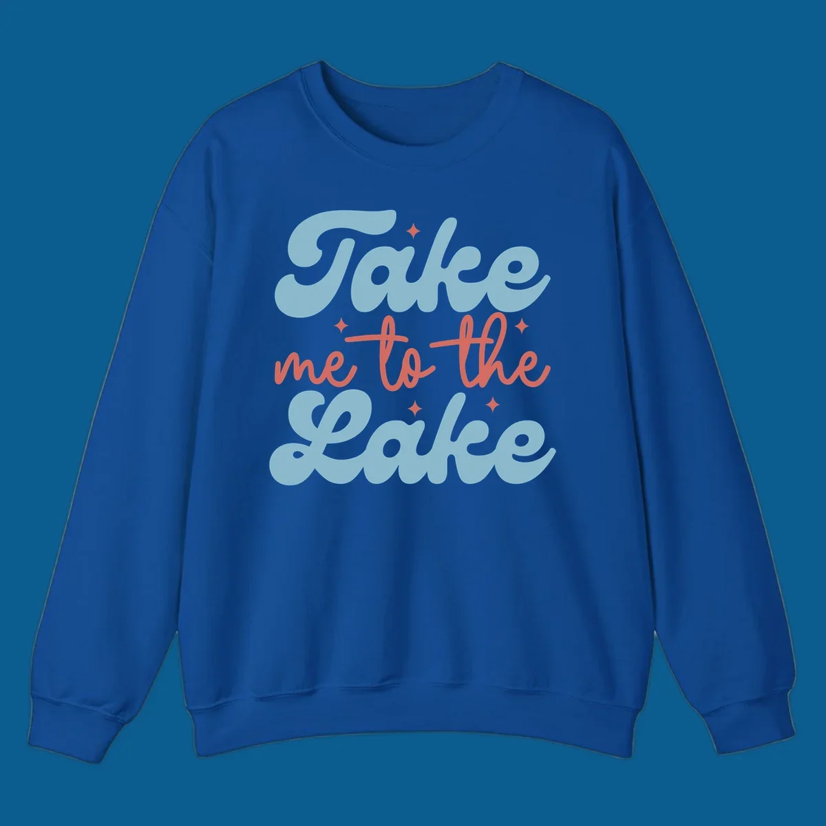 Retro 'Take me to the lake' text design with blue and coral lettering and white starbursts.