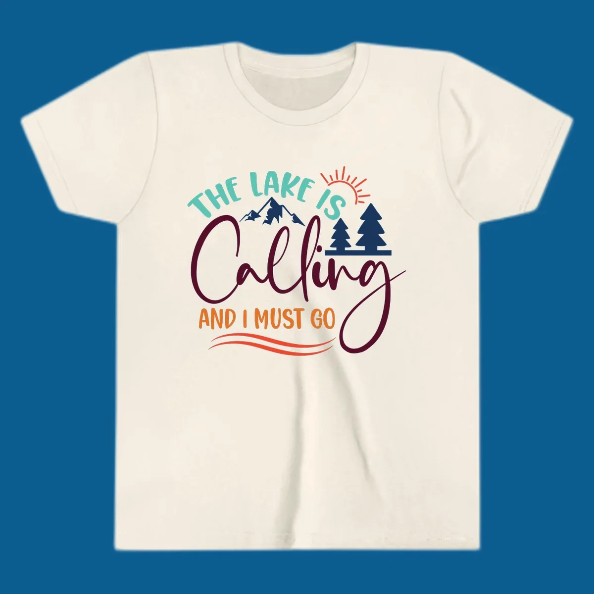 The Lake Is Calling And I Must Go nature graphic with mountains, trees, and sun rays.