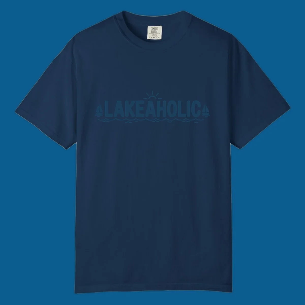 Lakeaholic typography with sun, sailboats, and waves graphic.