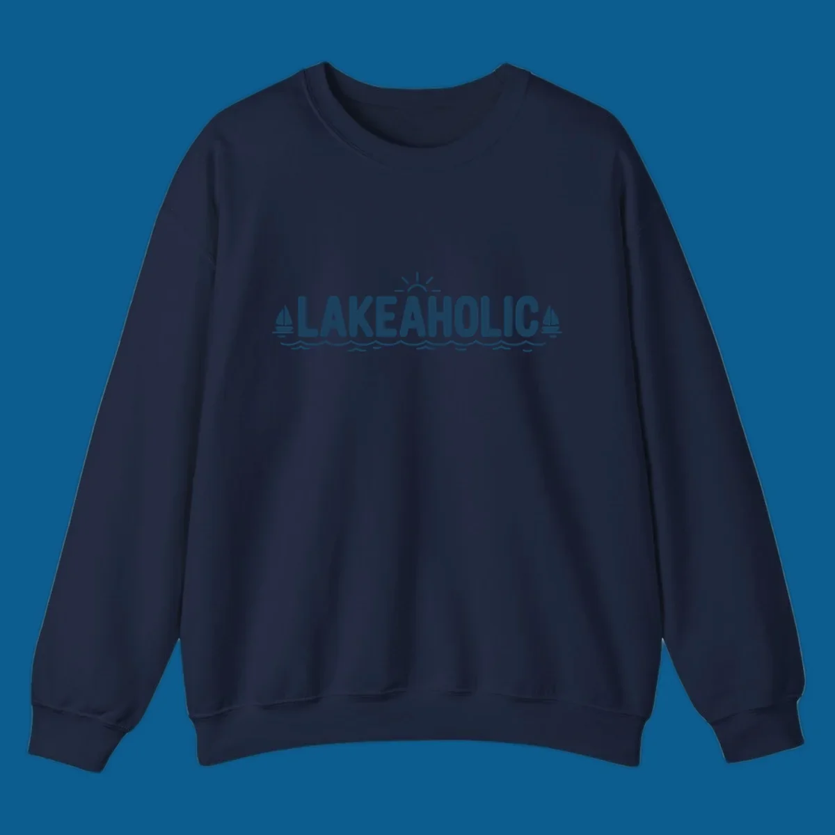 Lakeaholic typography with sun, sailboats, and waves graphic.
