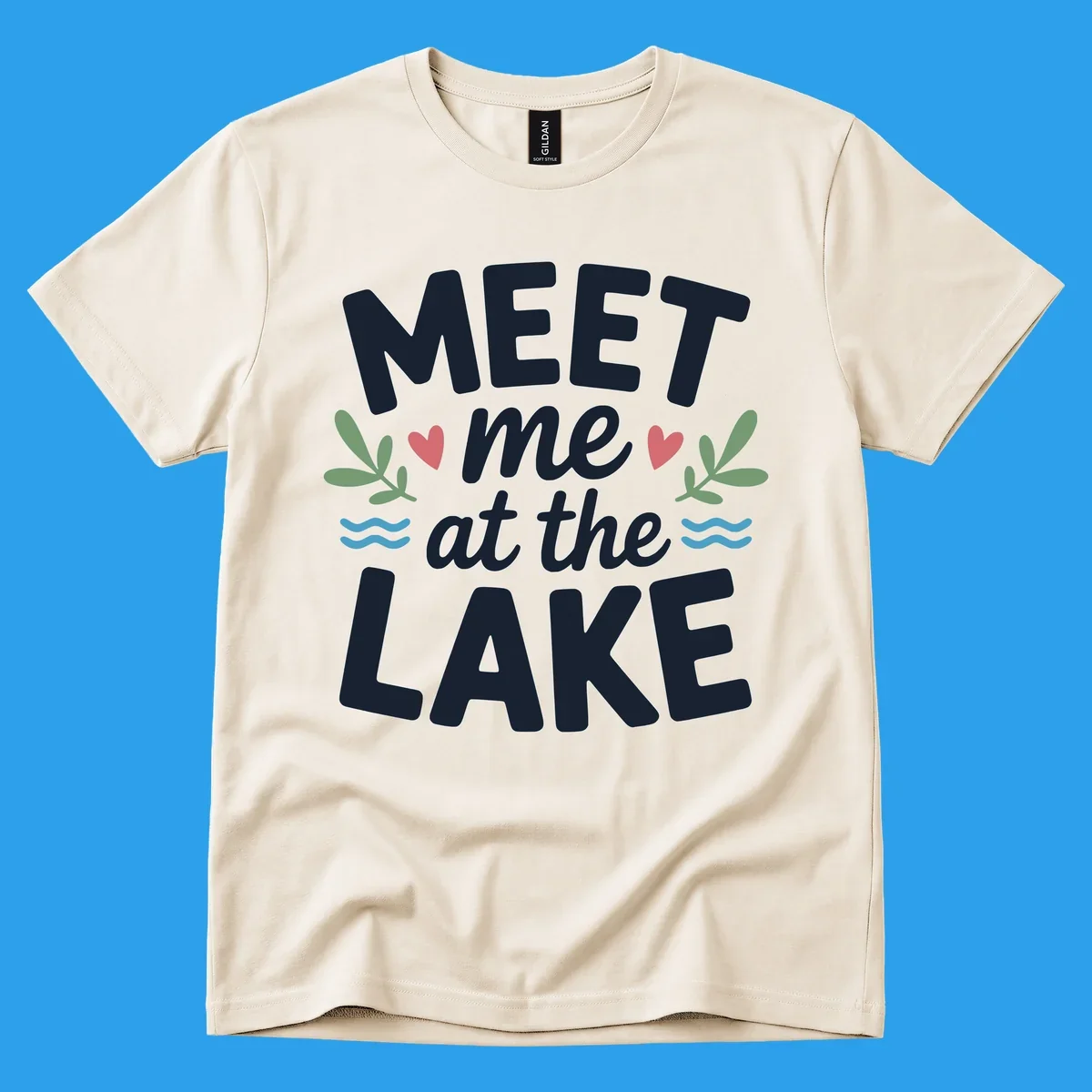 Meet me at the lake typography design with hearts, leaves, and waves.