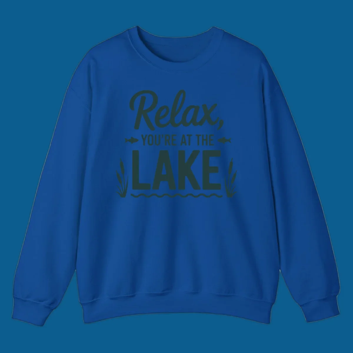 Relax you're at the lake typographic design with fish and cattails.