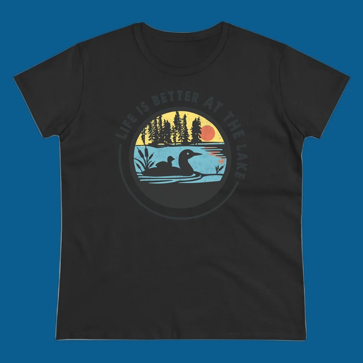 Circular lake scene with loons and trees, text "Life Is Better At The Lake".