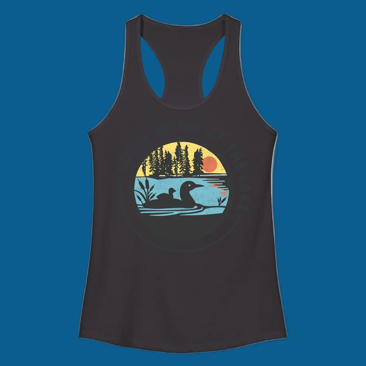 Circular lake scene with loons and trees, text "Life Is Better At The Lake".