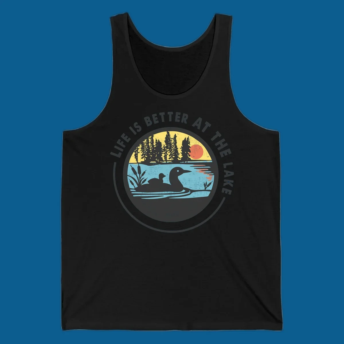 Circular lake scene with loons and trees, text "Life Is Better At The Lake".