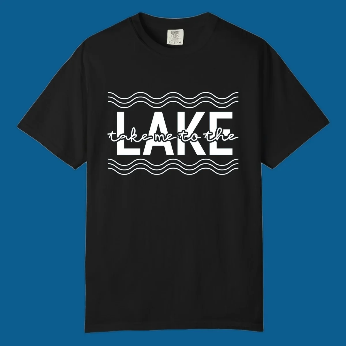 Lake life typography design with text 'take me to the LAKE' and wavy lines.