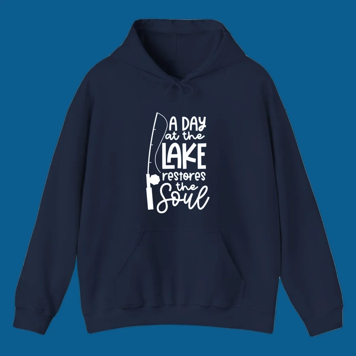 Fishing pole with text "A Day at the Lake Restores the Soul", lake-life concept.