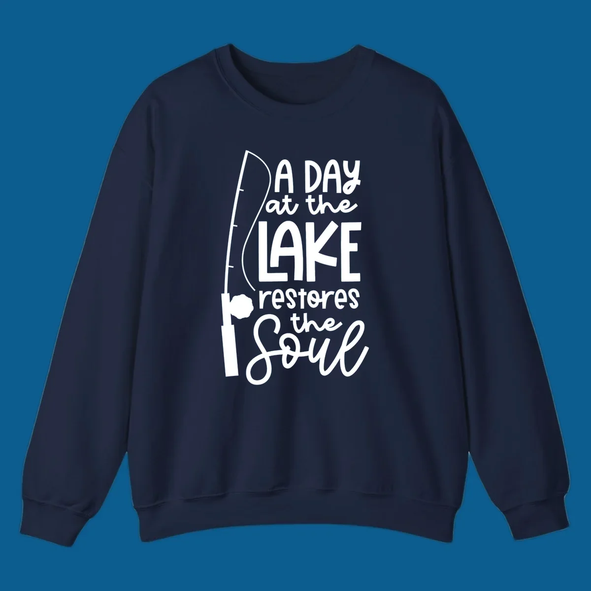 Fishing pole with text "A Day at the Lake Restores the Soul", lake-life concept.