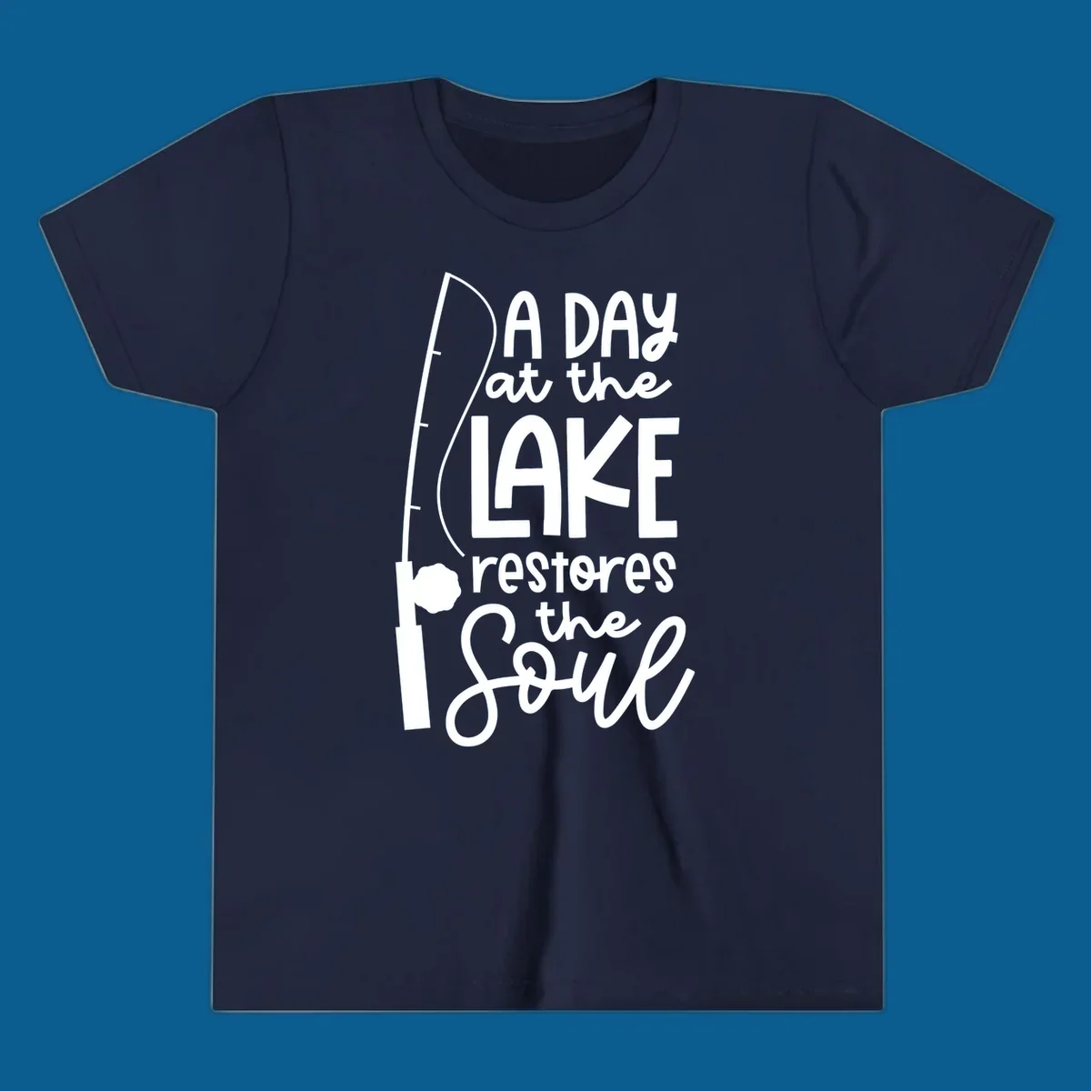 Fishing pole with text "A Day at the Lake Restores the Soul", lake-life concept.