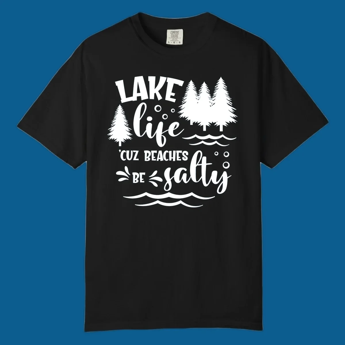 Lake life graphic with text 'LAKE life 'CUZ BEACHES BE salty', pine trees, and water waves.