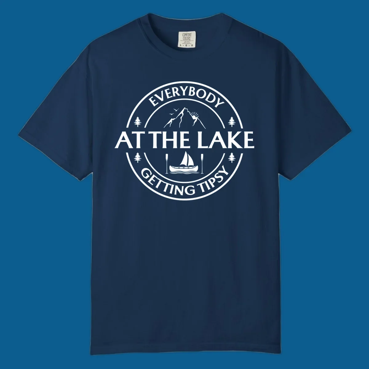 Circular badge design for lake life featuring mountains, canoe, and text 'Everybody At The Lake Getting Tipsy'.
