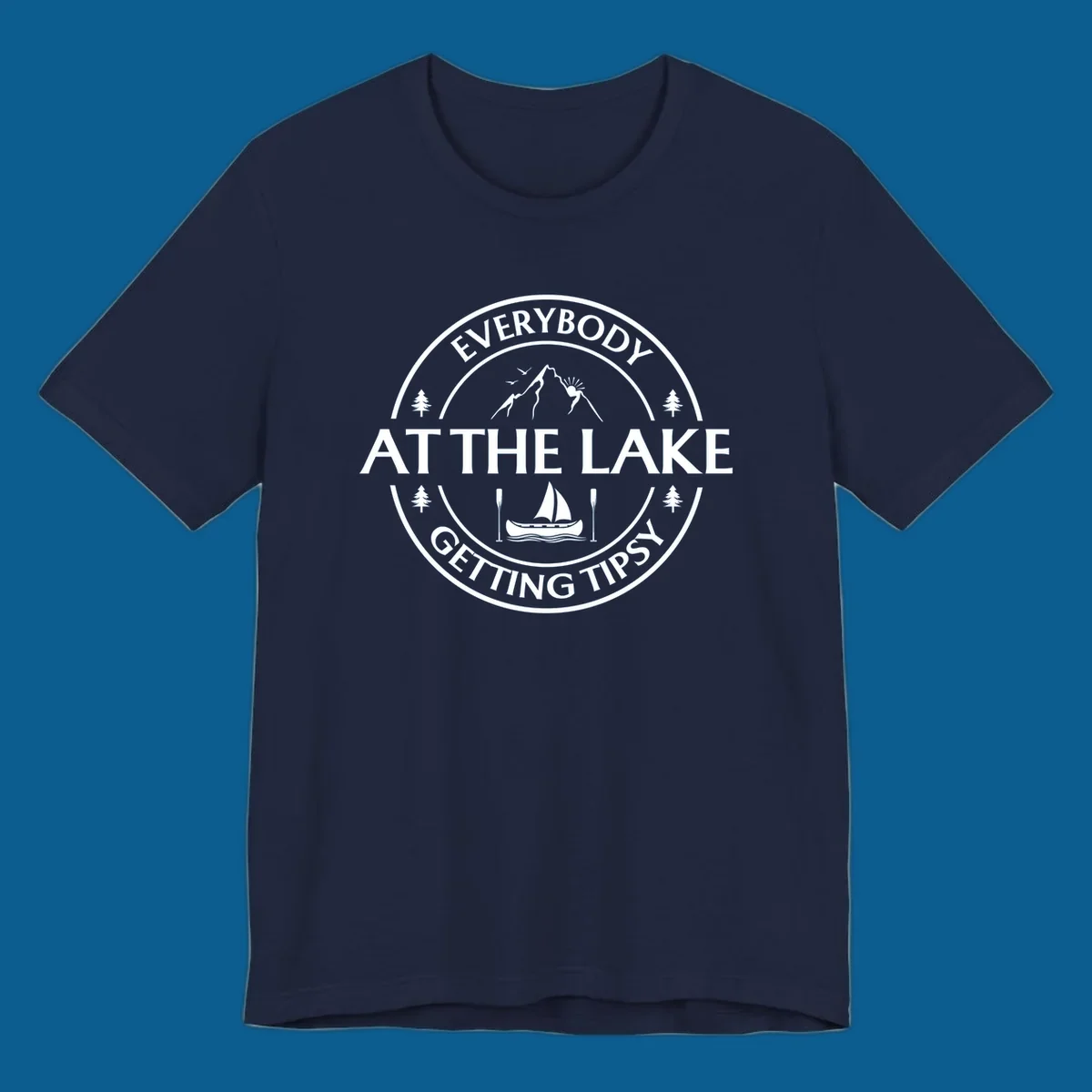 Circular badge design for lake life featuring mountains, canoe, and text 'Everybody At The Lake Getting Tipsy'.