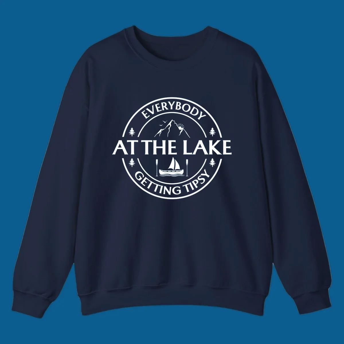 Circular badge design for lake life featuring mountains, canoe, and text 'Everybody At The Lake Getting Tipsy'.