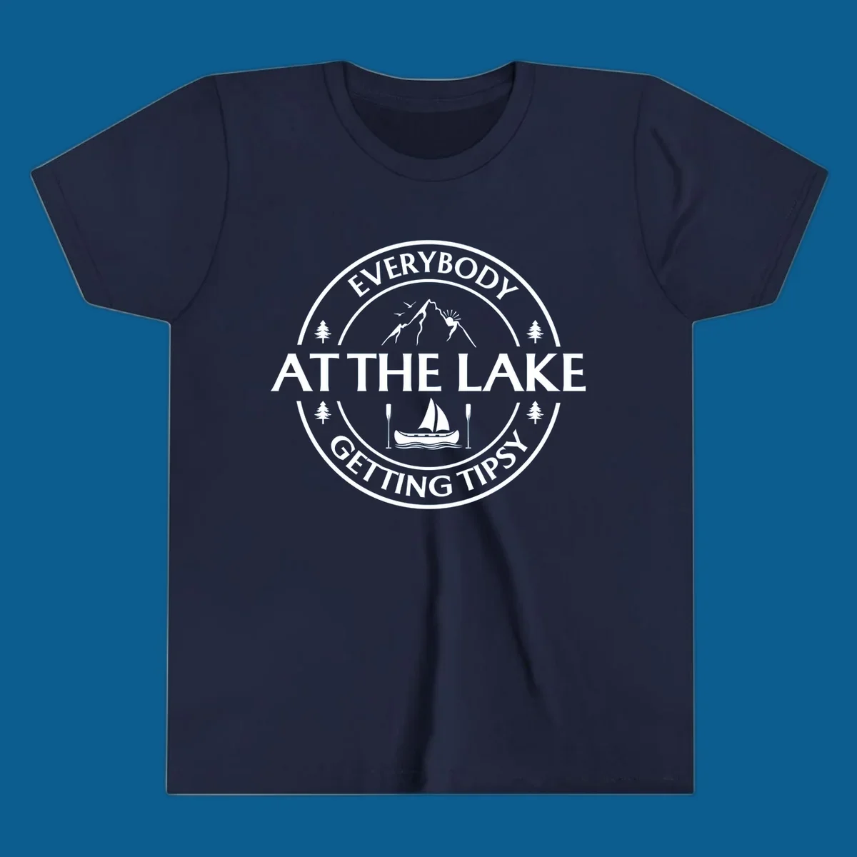 Circular badge design for lake life featuring mountains, canoe, and text 'Everybody At The Lake Getting Tipsy'.