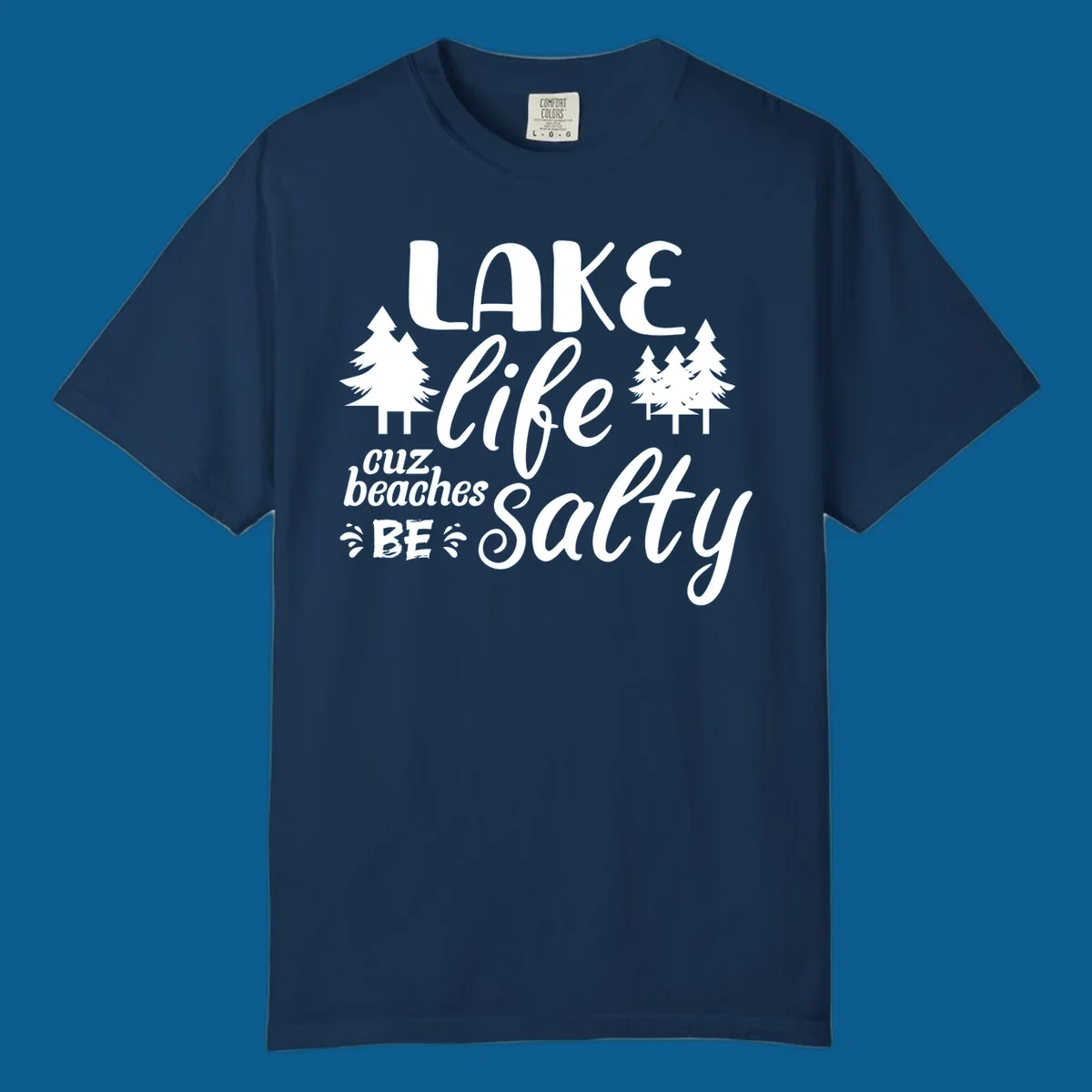 Lake life cuz beaches be salty text and pine trees graphic.