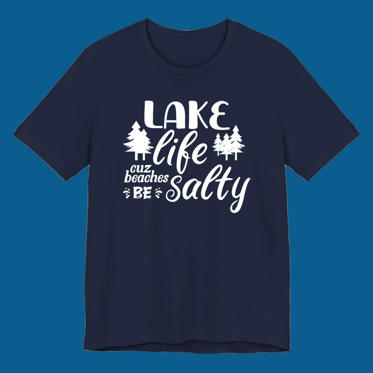Lake life cuz beaches be salty text and pine trees graphic.