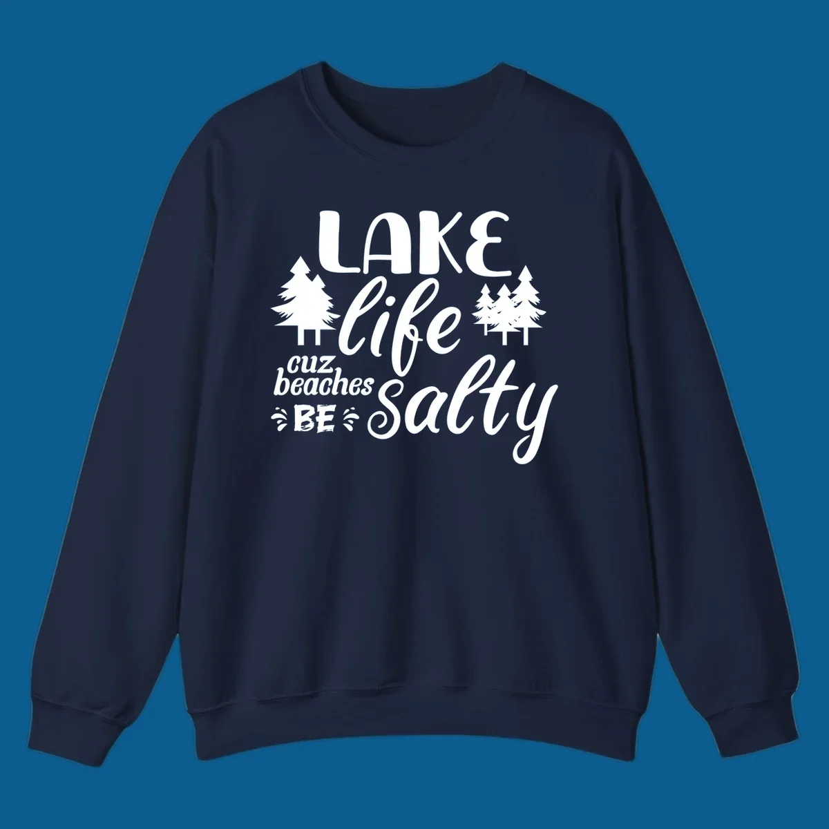 Lake life cuz beaches be salty text and pine trees graphic.