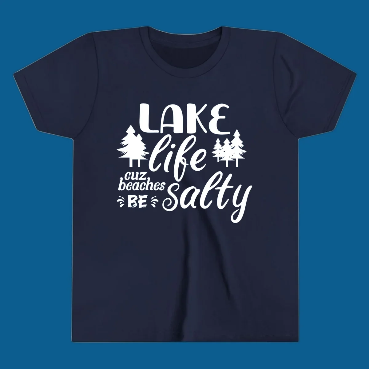 Lake life cuz beaches be salty text and pine trees graphic.