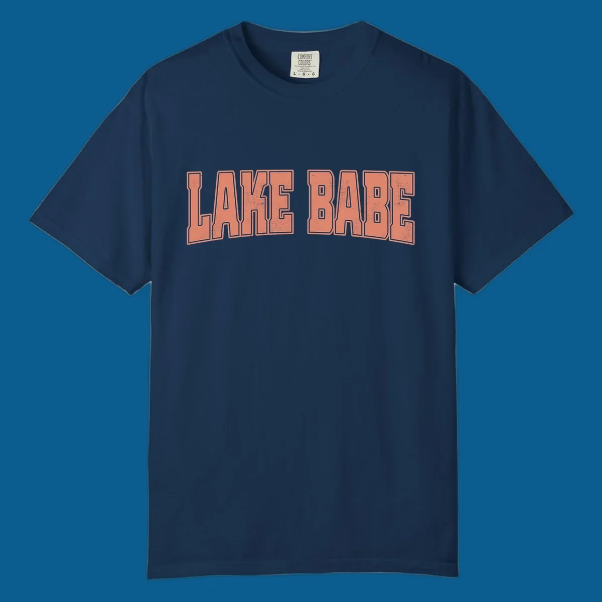 Lake Babe text in coral with distressed texture and thick outline, on black and white backgrounds.