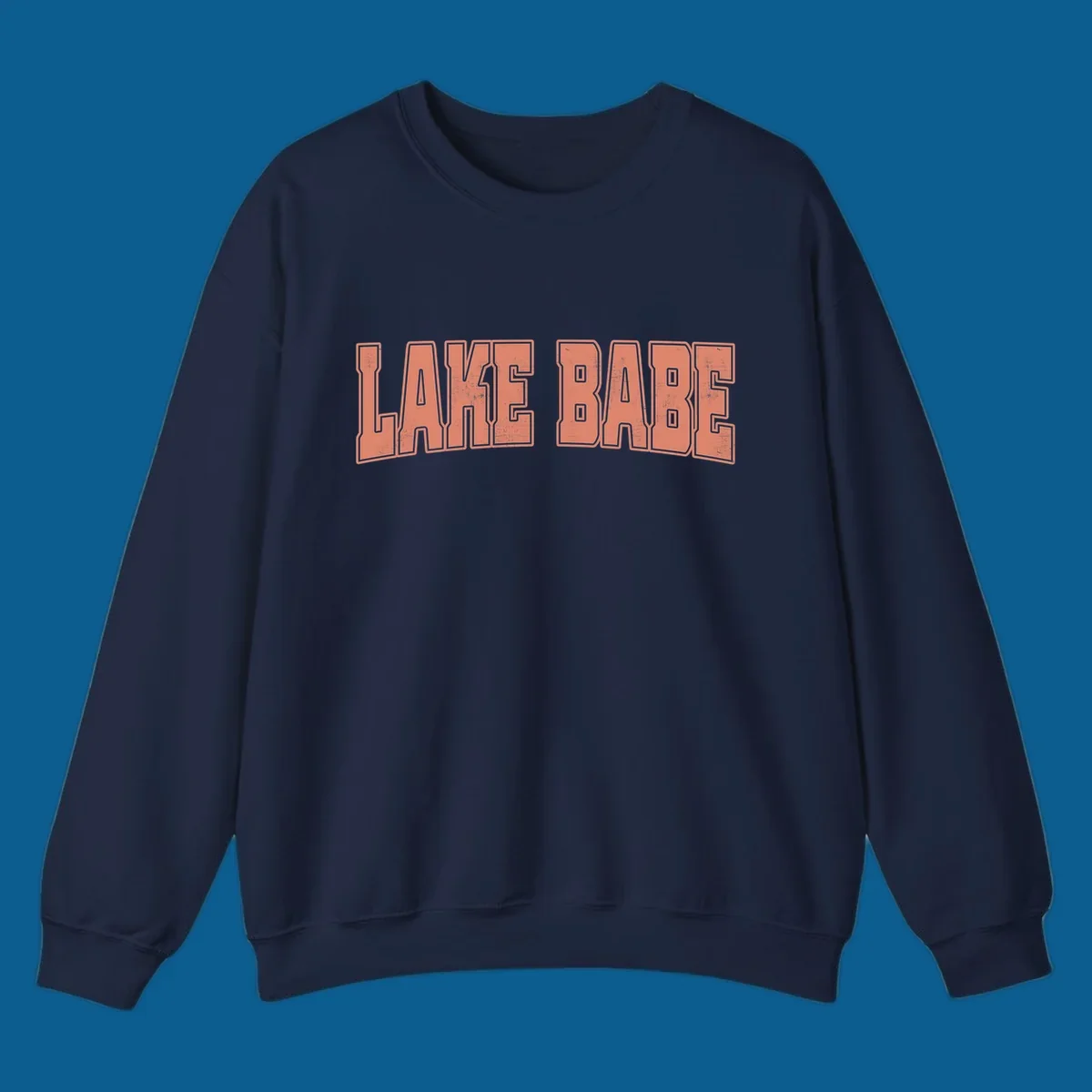 Lake Babe text in coral with distressed texture and thick outline, on black and white backgrounds.