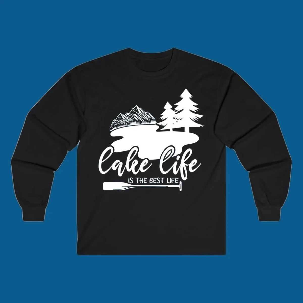 Lake life is the best life design with mountains, trees, lake, and paddle graphic.