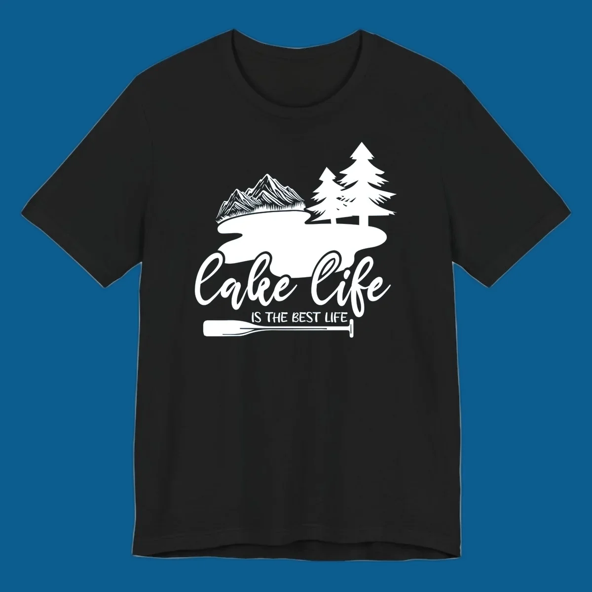 Lake life is the best life design with mountains, trees, lake, and paddle graphic.