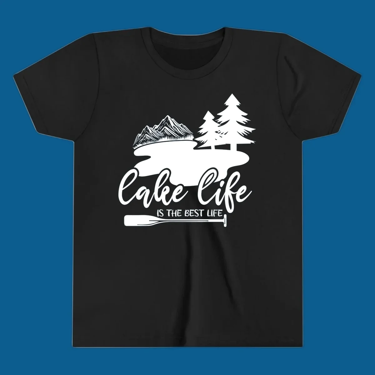 Lake life is the best life design with mountains, trees, lake, and paddle graphic.