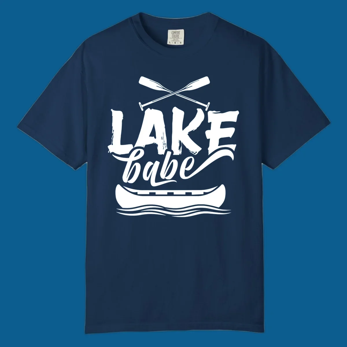 Lake babe text with canoe and oars on water. Primary keyword: lake-babe-canoe
