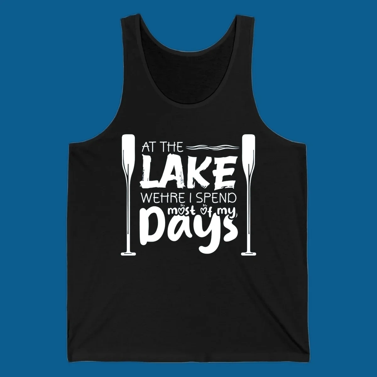 Text design "At The Lake Where I Spend Most Of My Days" with paddles and waves, lake-life-days concept.