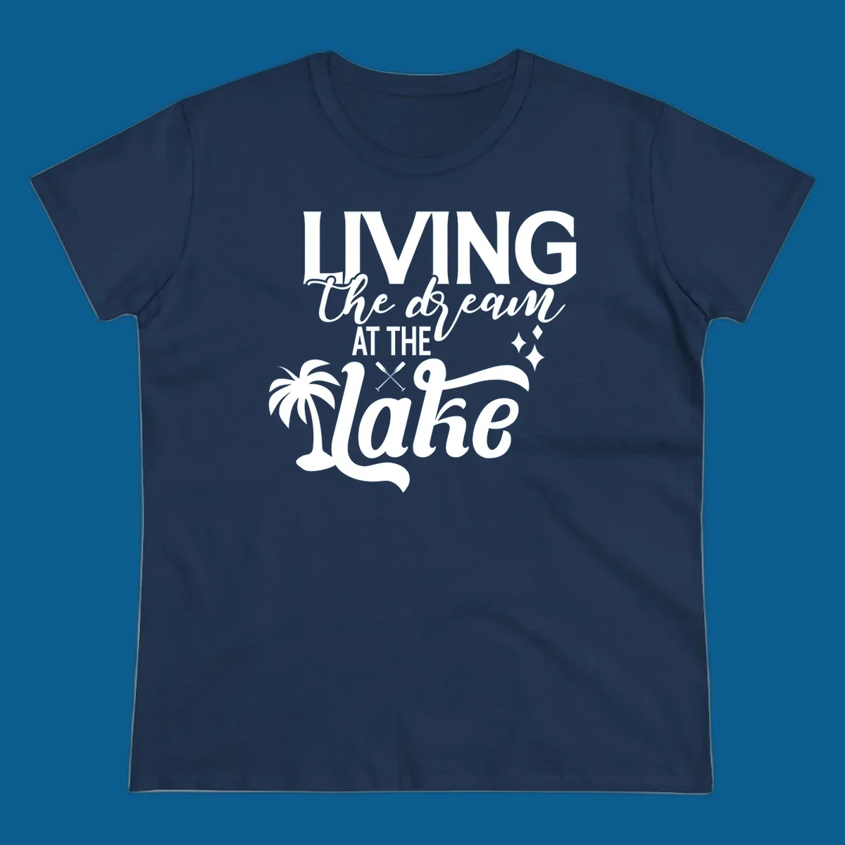 Living the dream at the lake text with palm tree and oars graphic