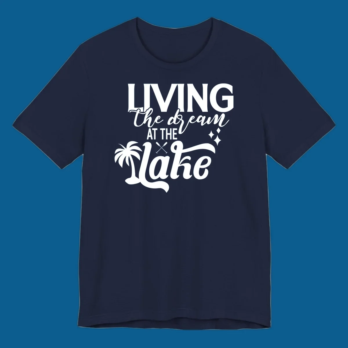 Living the dream at the lake text with palm tree and oars graphic