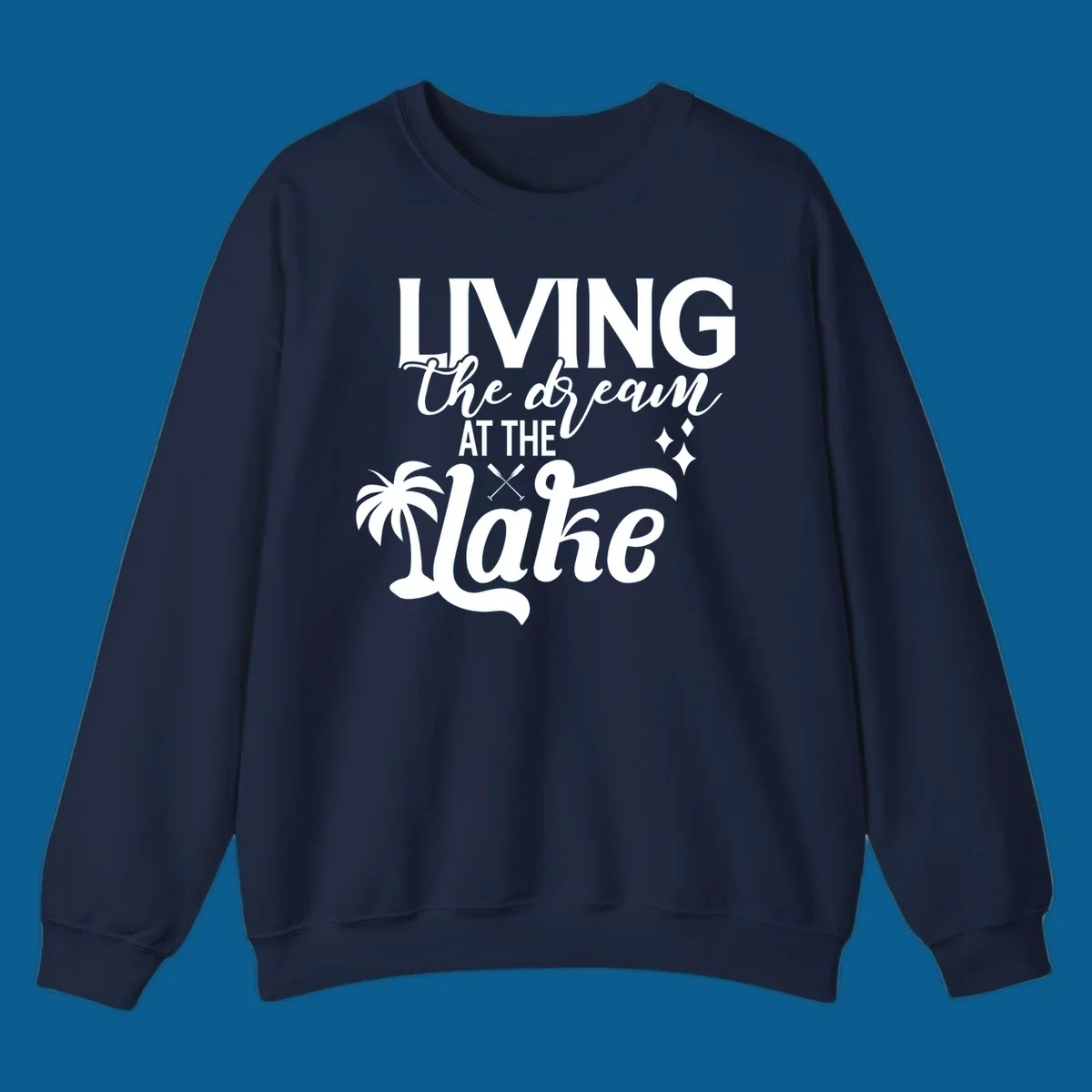 Living the dream at the lake text with palm tree and oars graphic