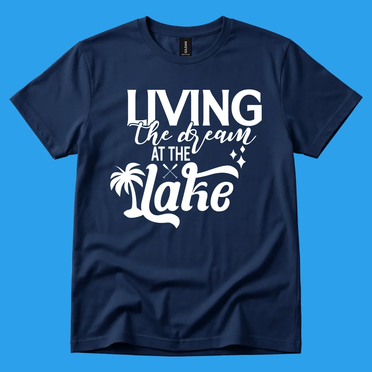 Living the dream at the lake text with palm tree and oars graphic